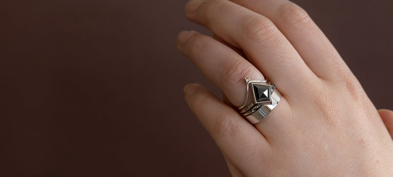 Black Diamond Engagement Ring in 14K White Gold on Model with Burgundy Background