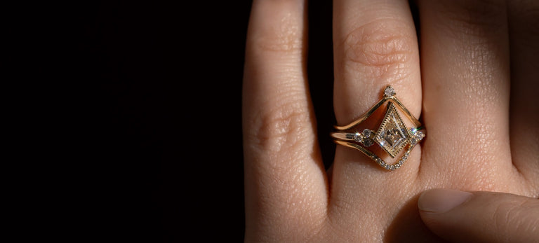 Model wearing lab grown white diamond engagement ring on black background