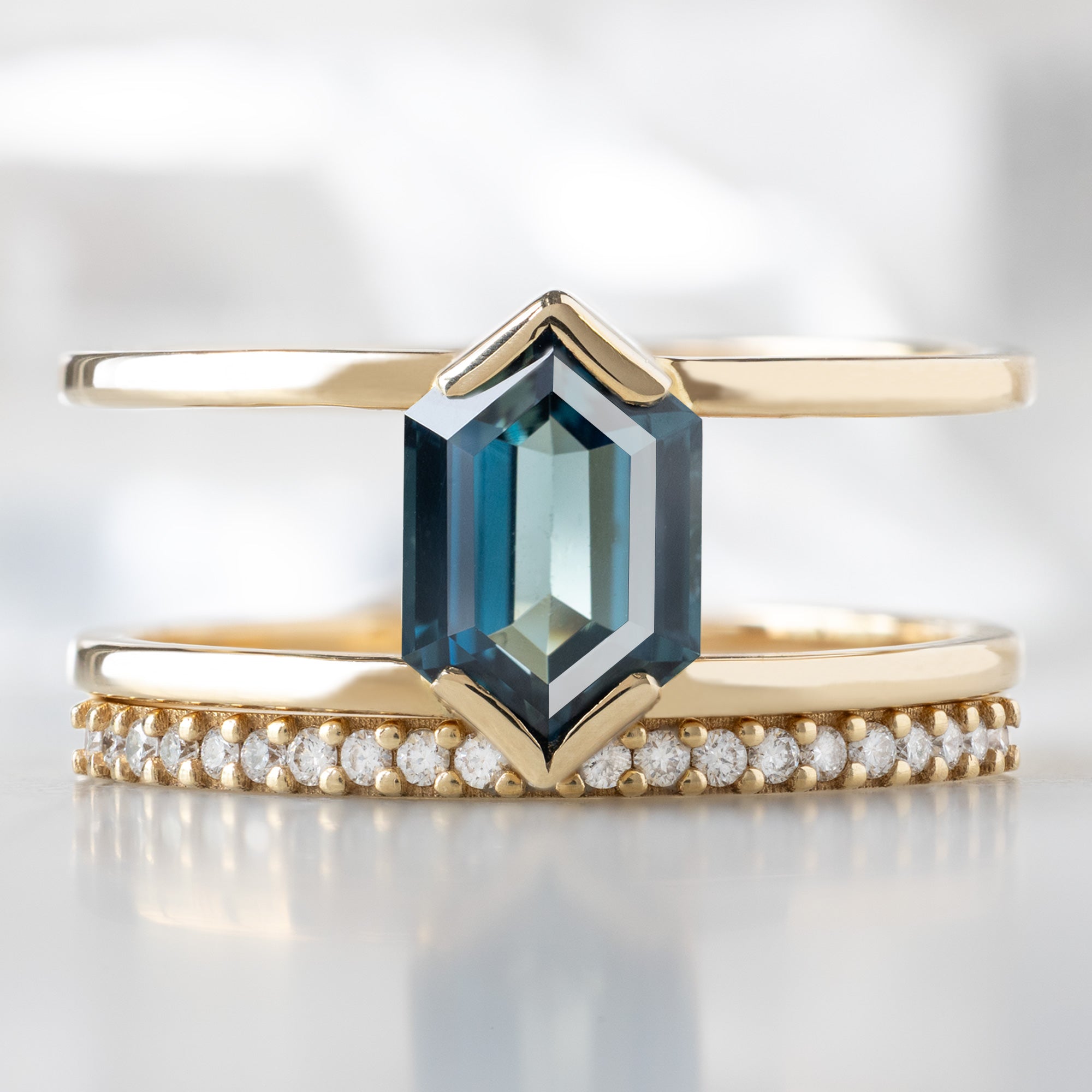buy:the-poppy-ring-1-24ct-hexagon-blue-sapphire-in-14k-yellow-gold,the-white-diamond-pave-wedding-band-14k-or-18k-yellow-gold