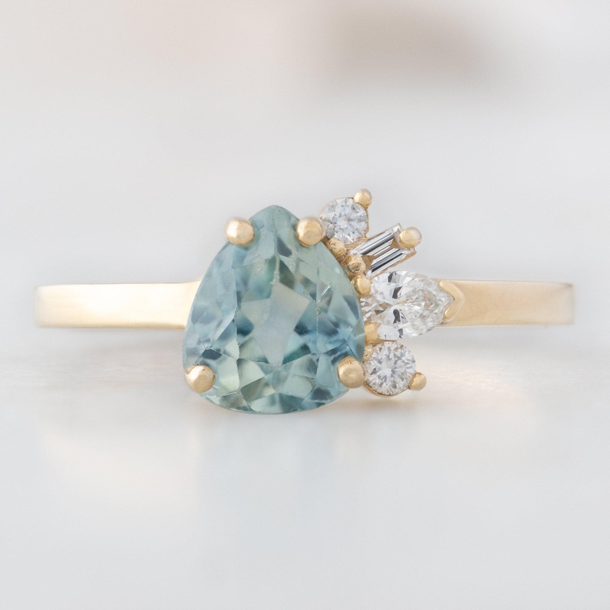 Alexis Russell Engagement Rings The Cluster Ring | 0.84ct Pear Cut Montana Sapphire in 14K Yellow Gold