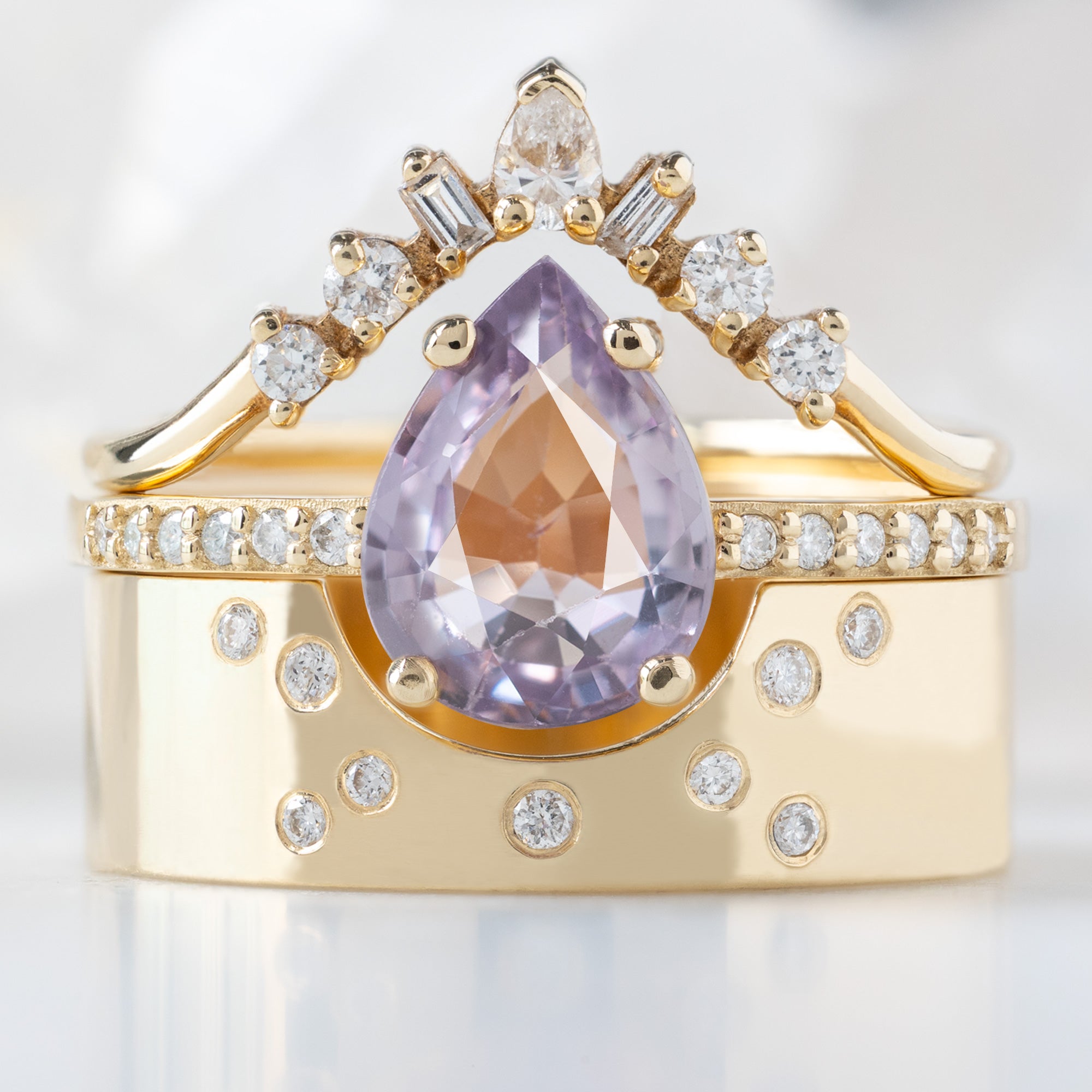 buy:geometric-white-diamond-sunburst-stacking-band-14k-or-18k-yellow-gold,the-willow-ring-1-38ct-pear-violet-sapphire-in-14k-yellow-gold,constellation-cut-out-stacking-band-arc-cut-out-in-14k-yellow-gold
