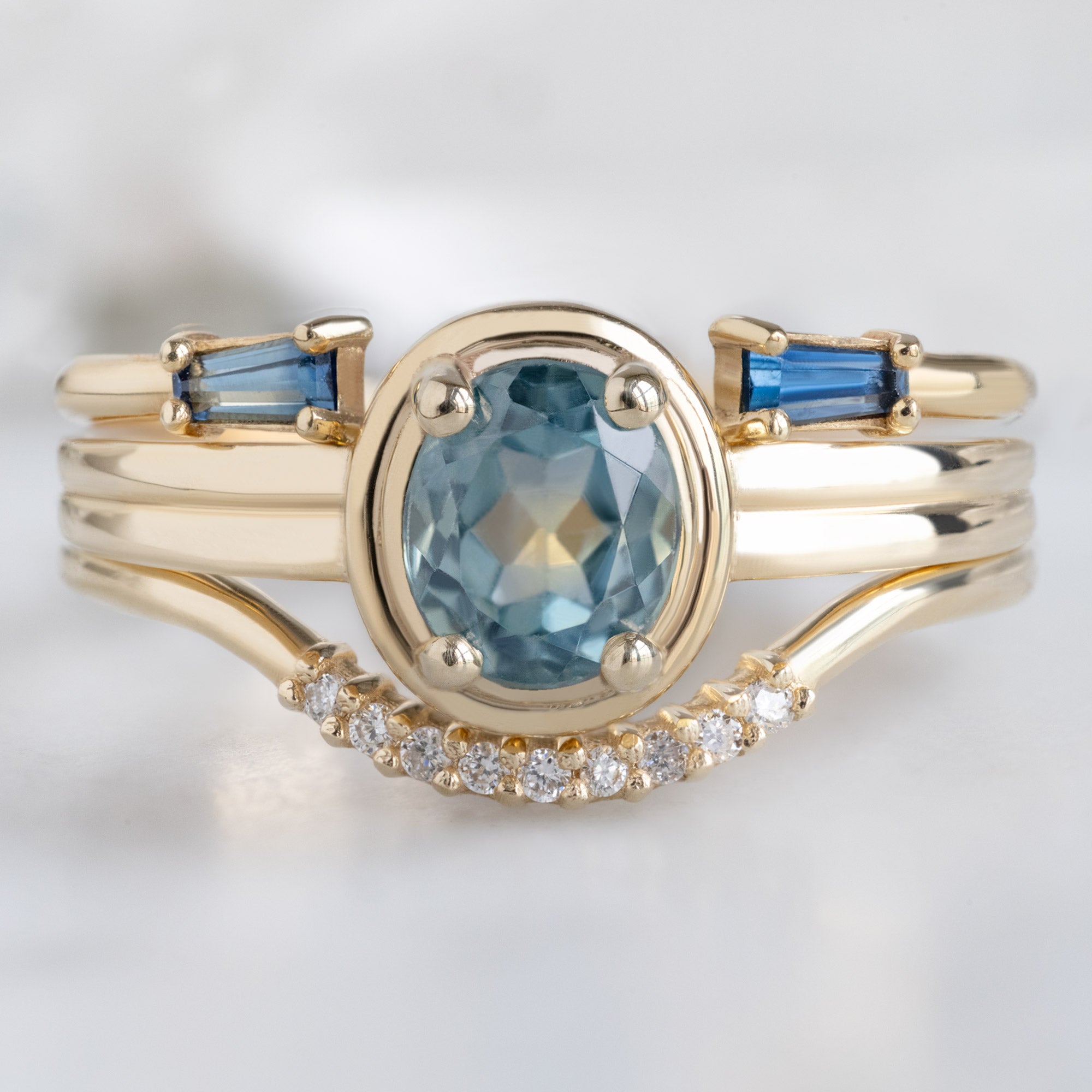 buy:open-cuff-montana-sapphire-baguette-stacking-band-14k-or-18k-yellow-gold,the-stratum-ring-72ct-oval-montana-sapphire-in-14k-yellow-gold,white-diamond-pave-arc-stacking-band-14k-or-18k-yellow-gold