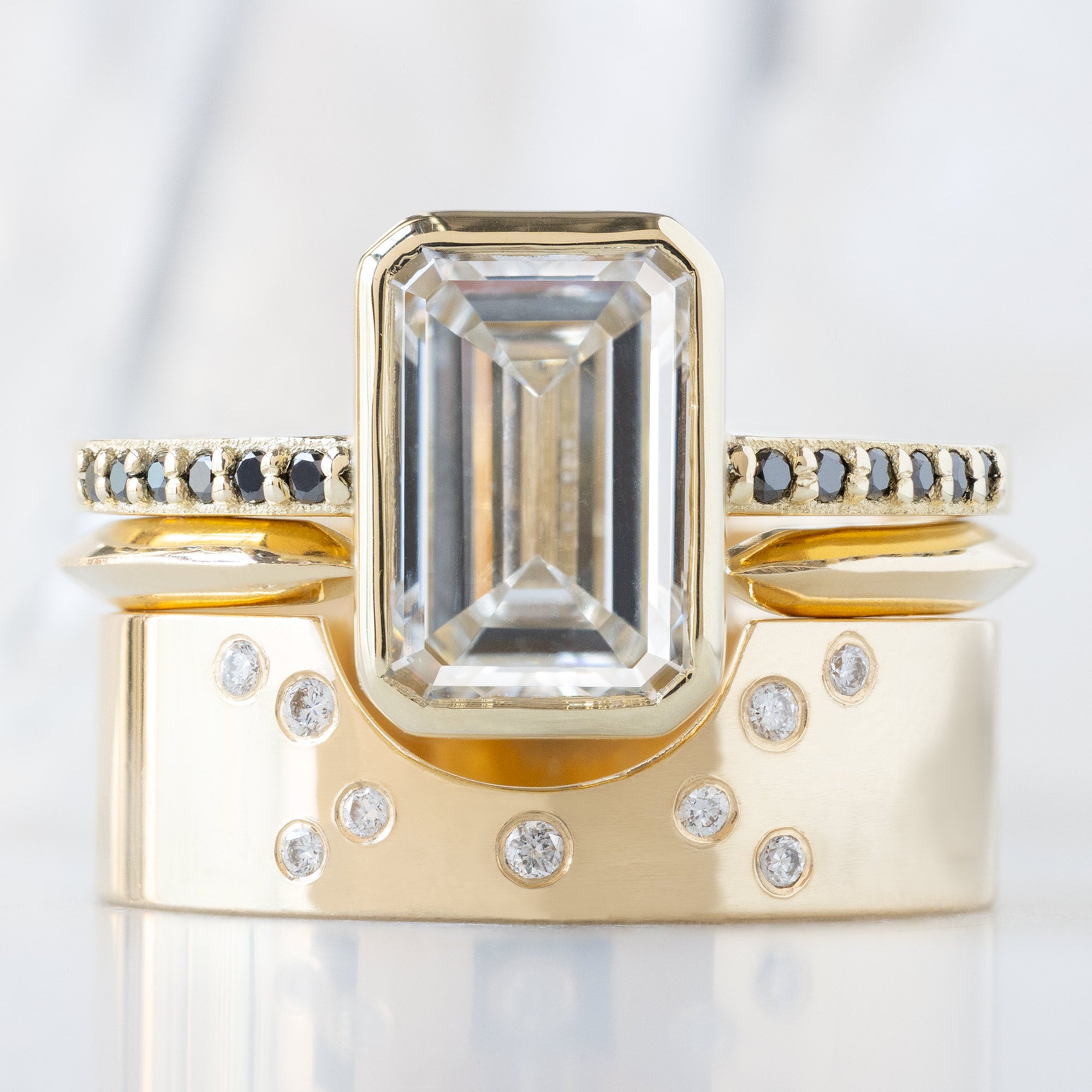 buy:the-willow-ring-2-50ct-lab-grown-white-emerald-cut-diamond-in-14k-yellow-gold,gold-open-cuff-knife-edge-stacking-band-14k-yellow-gold,constellation-cut-out-stacking-band-arc-cut-out-in-14k-yellow-gold