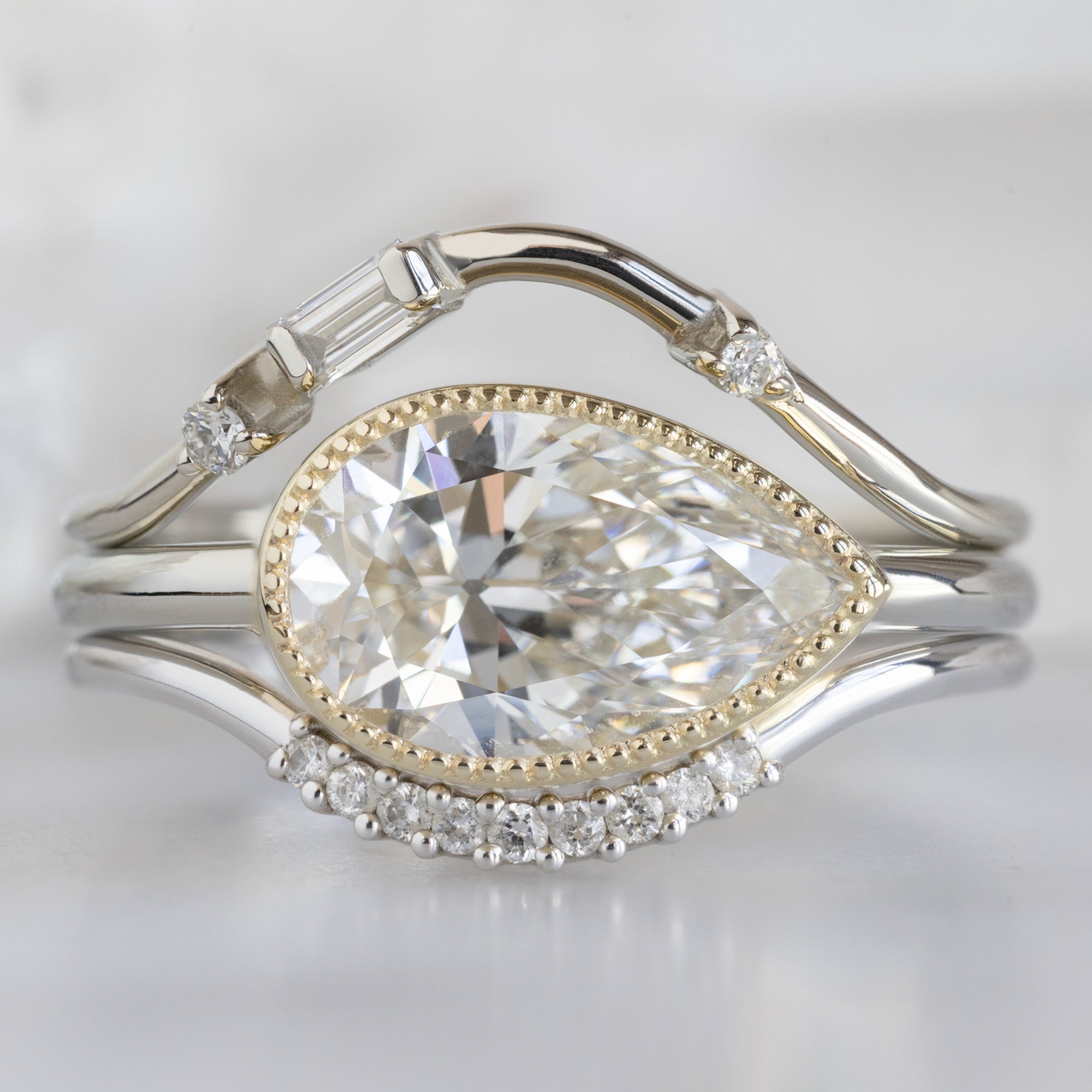 buy:asymmetrical-baguette-diamond-arc-stacking-band-in-14k-yellow-gold,the-milgrain-hazel-ring-1-79ct-lab-grown-pear-diamond-in-14k-yellow-gold,white-diamond-pave-arc-stacking-band-14k-or-18k-yellow-gold