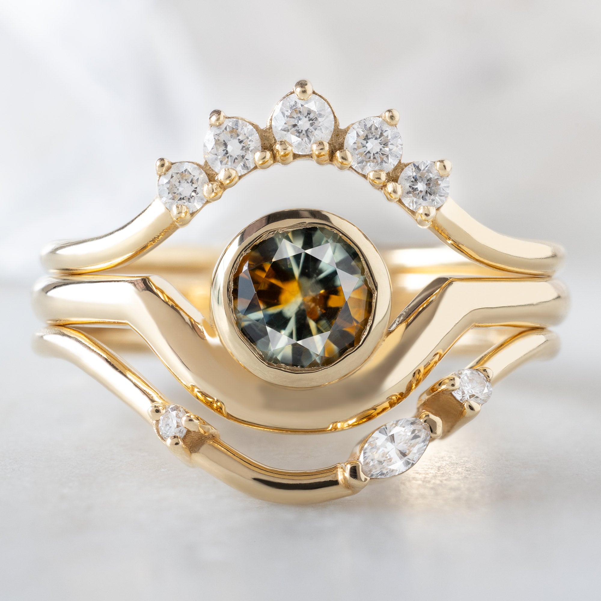 buy:round-white-diamond-sunburst-stacking-band-14k-or-18k-yellow-gold,the-watercolor-wave-ring-78ct-round-montana-parti-sapphire-in-14k-yellow-gold,asymmetrical-marquise-diamond-arc-stacking-band-in-14k-yellow-gold