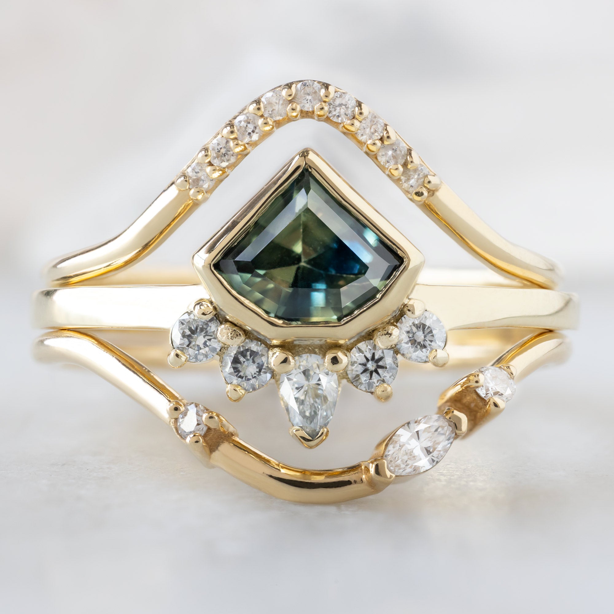buy:white-diamond-pave-peak-stacking-band-14k-or-18k-yellow-gold,the-watercolor-aster-ring-85ct-geometric-parti-sapphire-in-14k-yellow-gold,asymmetrical-marquise-diamond-arc-stacking-band-in-14k-yellow-gold