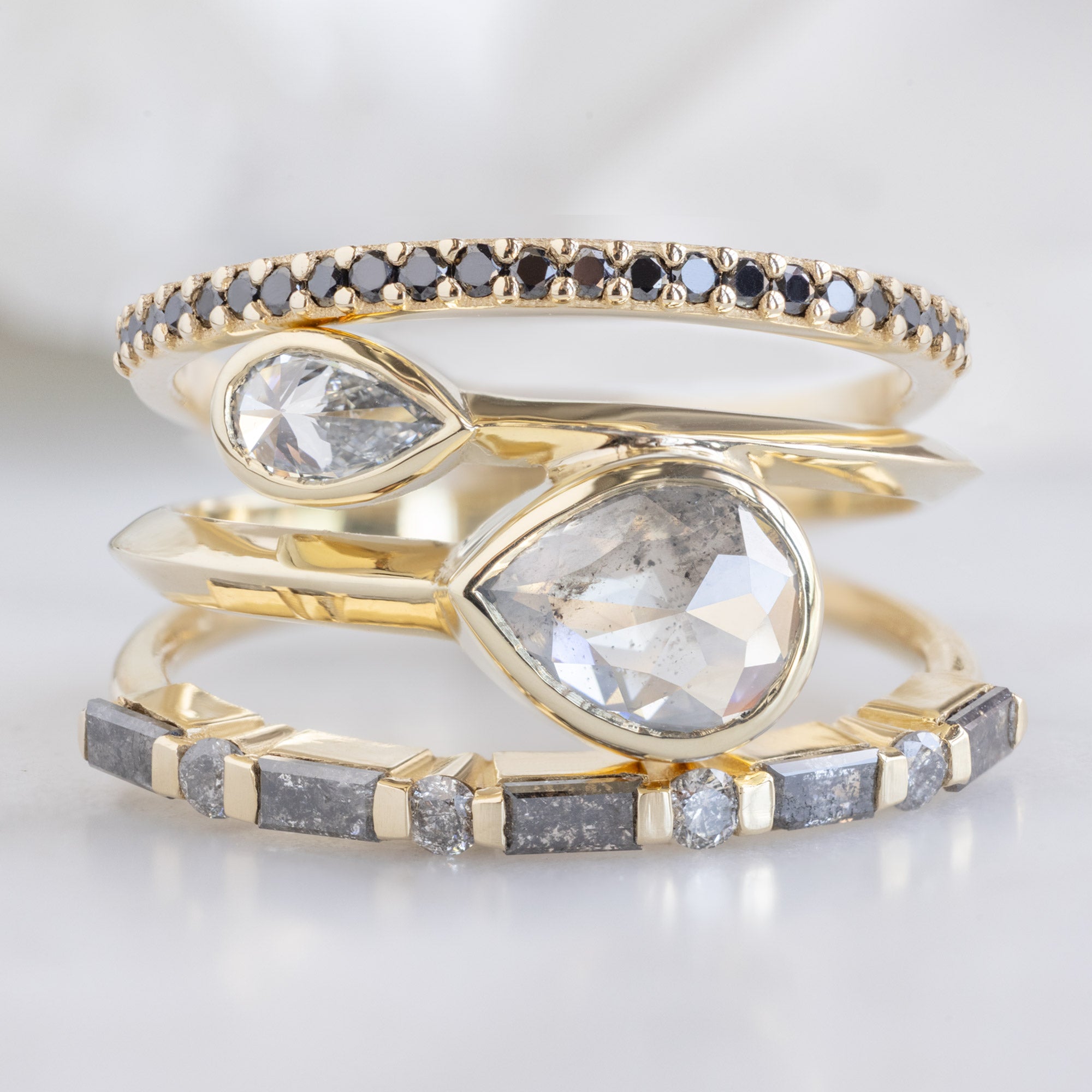 buy:the-black-diamond-pave-wedding-band-14k-or-18k-rose-gold,the-wrap-ring-with-a-1-09ct-pear-icy-white-diamond-in-14k-yellow-gold,the-luxe-baguette-salt-and-pepper-diamond-eternity-band-yellow-rose-or-white-gold